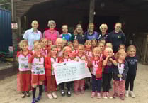 Rainbows present fundraising pot of gold to Erme Valley RDA