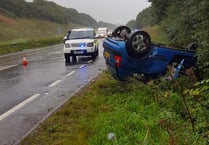 Car ends up on roof in heavy rain on A38