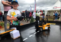 Mini forklifts on trade stand pull in young fans