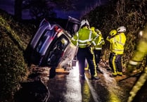 Fire crews help man escape as car ends up on its side