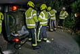 Driver ‘in good spirits’ after car ends up on its side in crash
