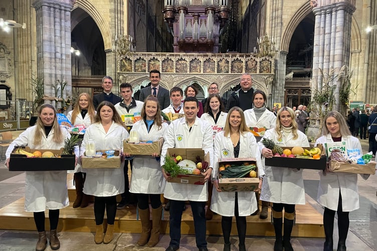 The YFC representatives with the offerings made during the service, with, back row, from left, Canon Chris Palmer, Paul Glanville, Deputy Lord Mayor of Exeter, Cllr Tess Read, Vicki Gilbert and Dean, the Very Rev Jonathan Greener. AQ 9586