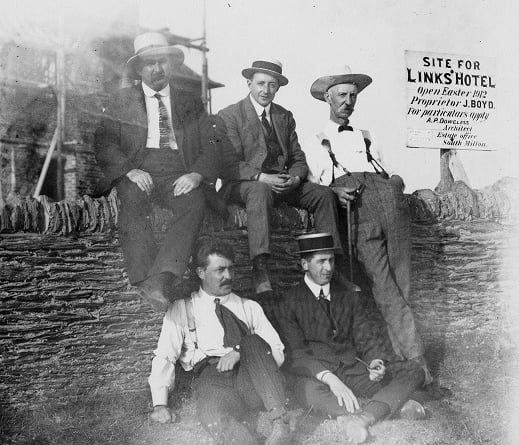 Pre 1912 Five men sitting on the wall outside uncompleted Links Hotel, Thurlestone. 
Back row: Joshua Boyce (in charge of building hotel), Edward John Tanner (clothier), Langworthy (butcher).  
Front row: unknown, William Stubbs (visitor on business with Tanner).