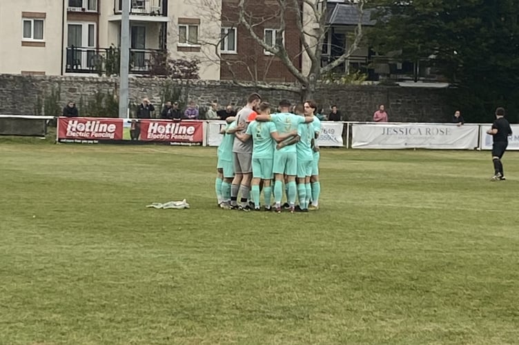 Ivybridge Town huddle before kick off against Newton Abbot Spurs