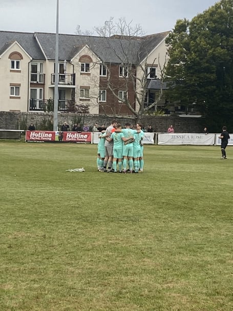 Ivybridge Town huddle before kick off against Newton Abbot Spurs