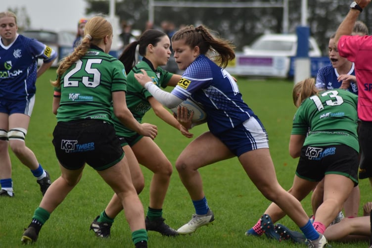 Fly-half Amelia Benfield (with the ball) helped Scarlett Murgatroyd with her second try