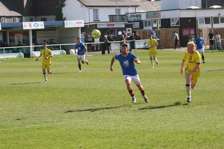 Owen Green, of Newton Abbot Spurs, with eyes on the ball against Okehampton Argyle