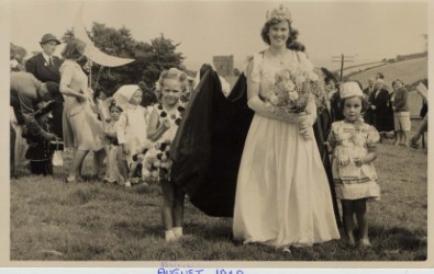 Stokenham Fete 1949, in fields behind the village hall. Stella Lee, Fair Queen, Sally Reeves on right, Amanda Lewis on left.