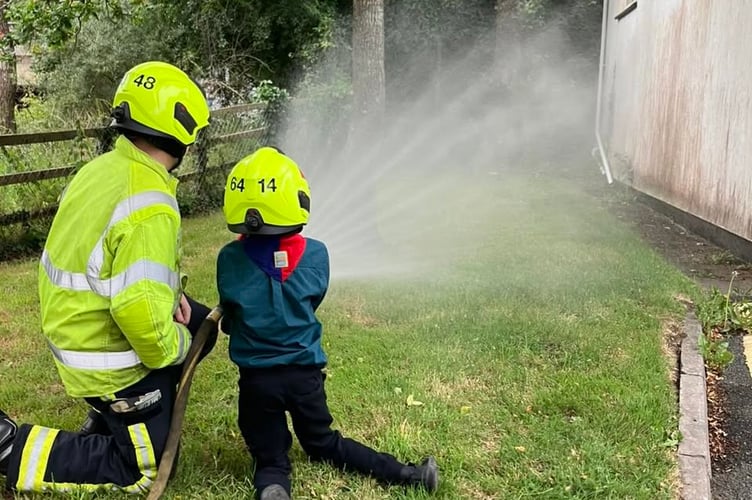 A scout tries out the hose