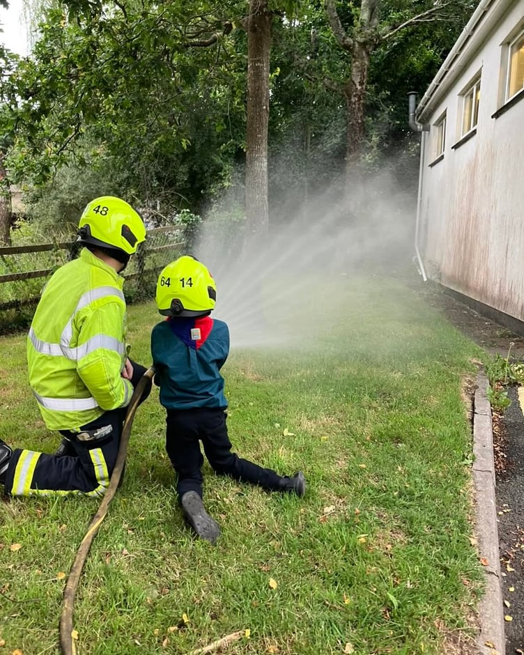 A scout tries out the hose