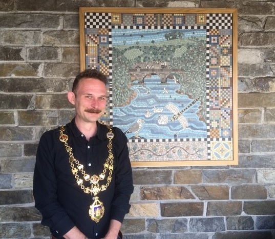 Mayor Cllr Tim Bennett with one of the mosaic panels