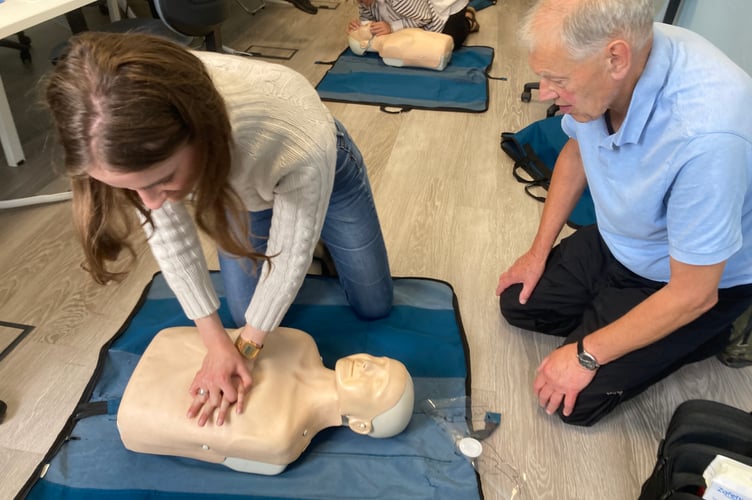Lulu Goad carries out compressions watched by first aid trainer Peter Juniper