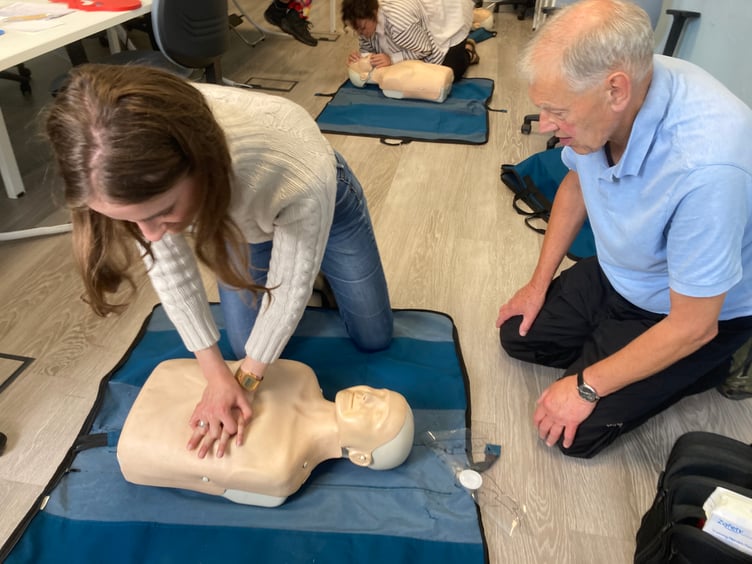 Lulu Goad carries out compressions watched by first aid trainer Peter Juniper