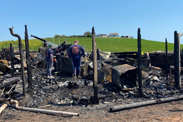 Beach House restaurant workers stood amongst the wreckage following the fire in May.