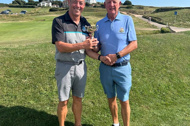 Ian Neal claims his prize from Thurlestone captain John Rogers