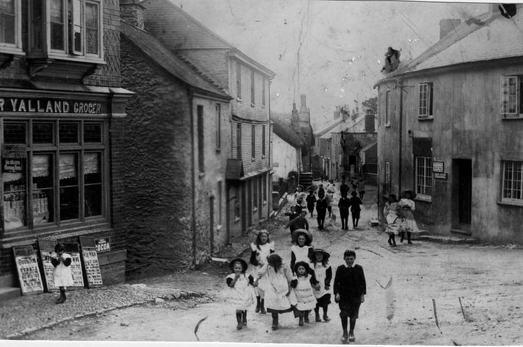 Around 1900 Crowd of children in centre of Loddiswell outside London House Stores