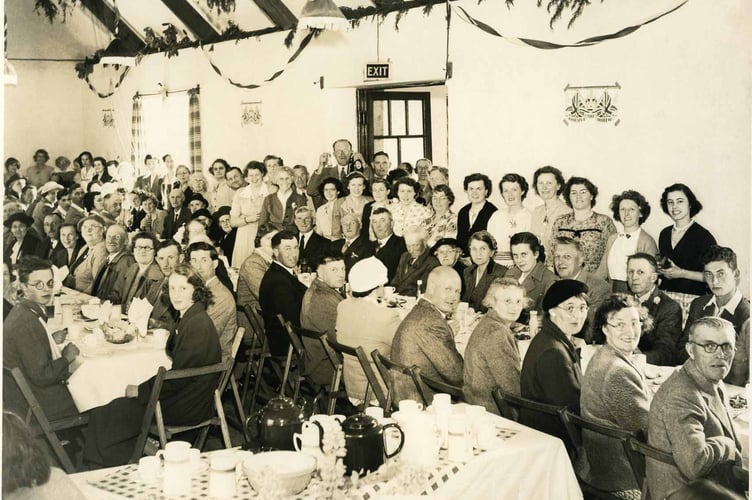 Group of people in the village hall, probably Stokenham. Includes H.Lee the postman.  Possibly 1953