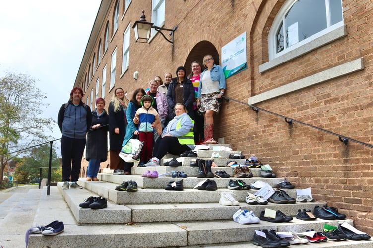 Protestors with the dozens of pairs of shoes outside County Hall