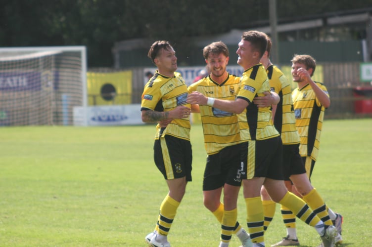 Sean Thomson is mobbed after striking a stunner against Newquay