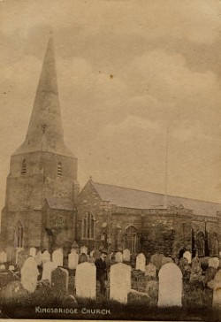 Pre-1921. All Saints Church and graveyard at Malborough with a man by a graveside.