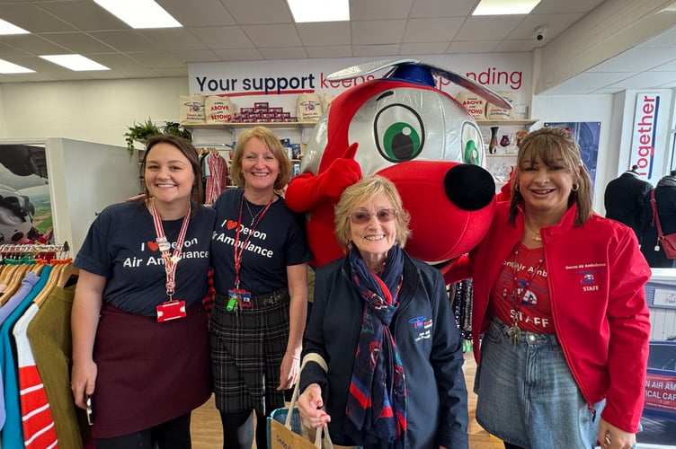 Ann Ralli, centre, with some of the Devon Air Ambulance staff and mascot Jennie. AQ 0064