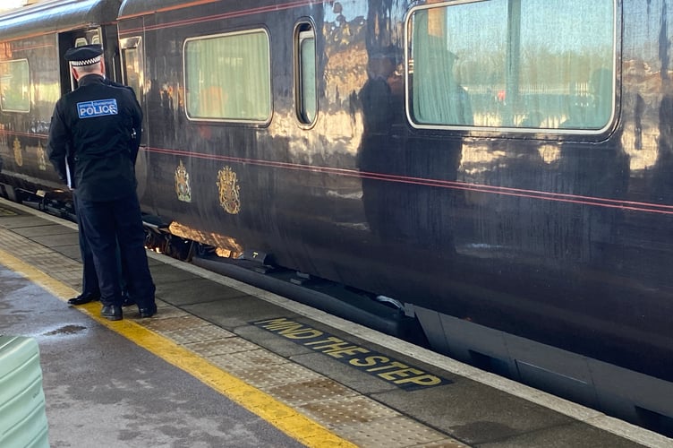 Officer guarding the Royal Messenger as King Charles arrives in Totnes.