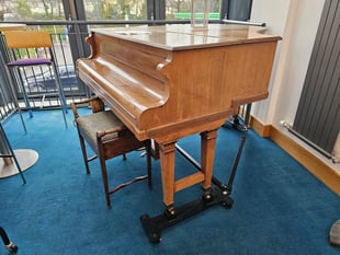 Watermark giving away baby grand piano 