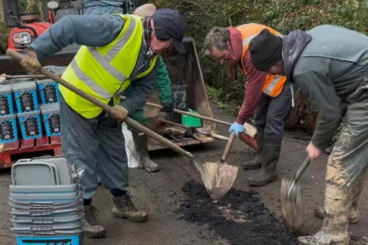 Road Warden Scheme volunteers repairing a pothole.